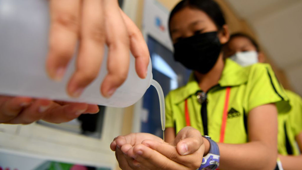 武汉肺炎期间,柬埔寨戴着口罩的学生排队等候,用酒精溶液消毒双手。.jpg 武汉肺炎期间,柬埔寨戴着口罩的学生排队等候,用酒精溶液消毒双手。.jpg